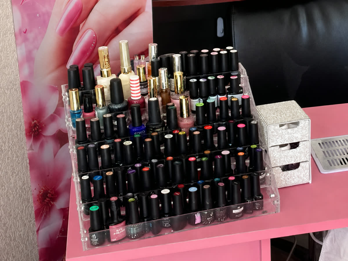 Rack of nail polish colours available at the studio